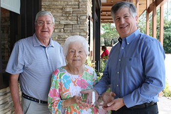From left, financial advisor Larry Craine, Mrs. Barbara Harter Rippy and Dean Philip Hall