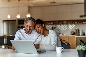 couple on a laptop in their kitchen